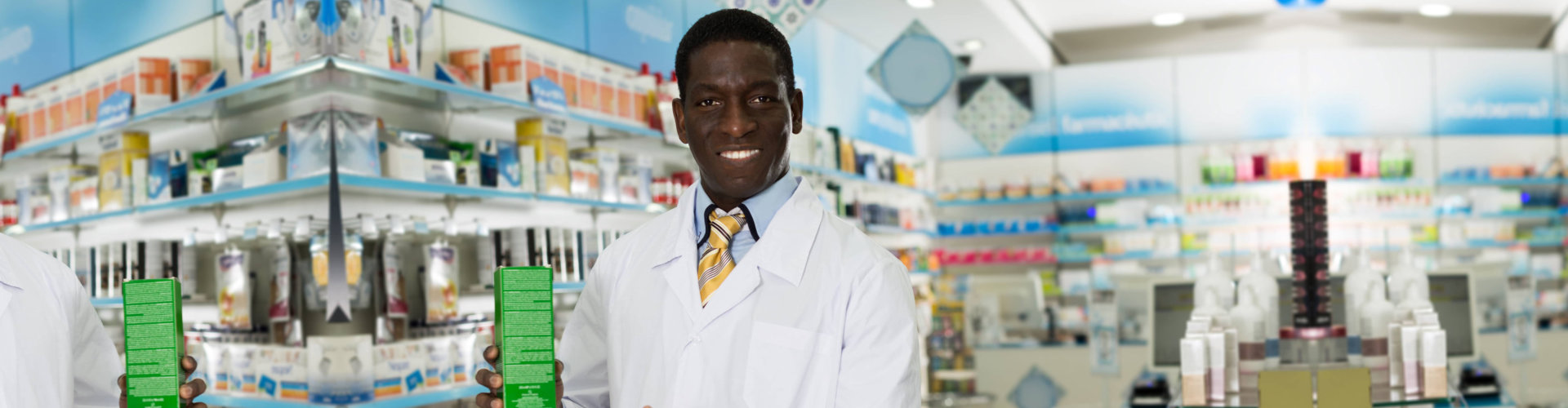 male pharmacist holding a medicine