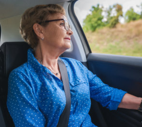senior woman riding a car