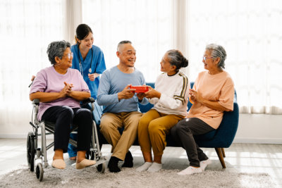 elderly man receiving gift boxes from friends on special occasion, Happy Lifestyle after retirement