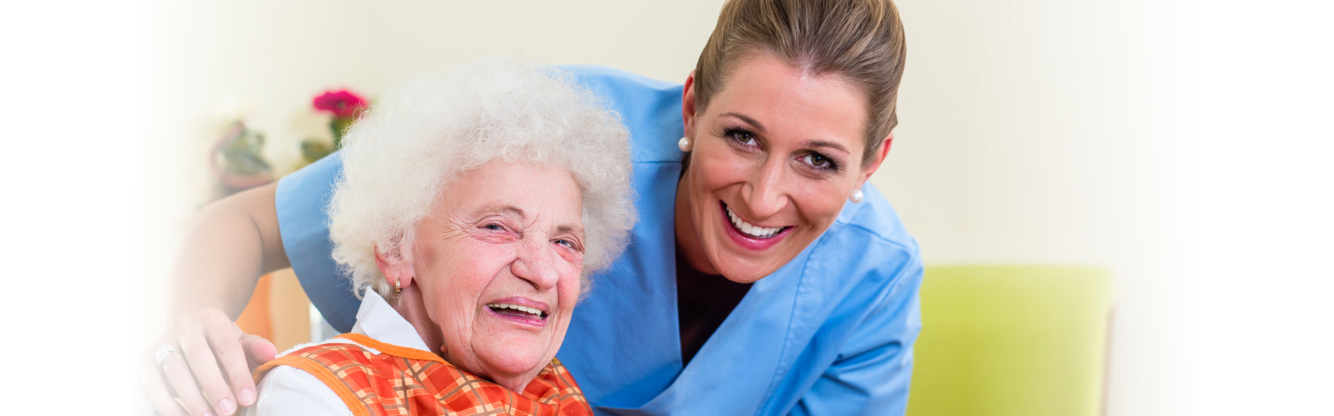 Senior and caregiver smiling