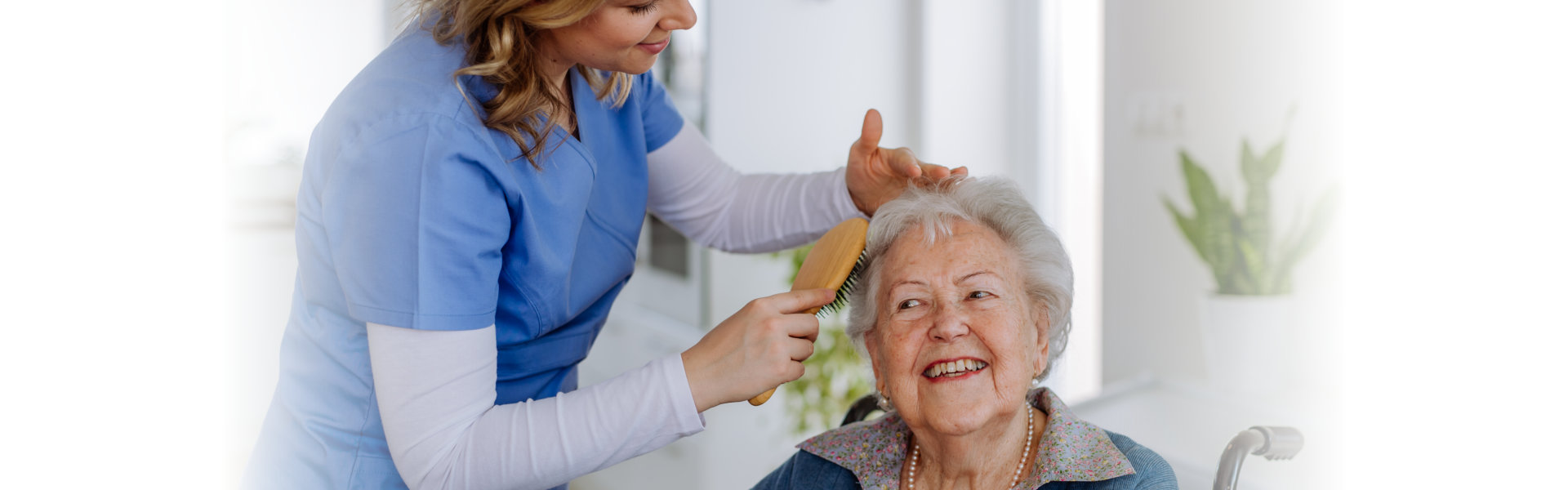 Caregiver combing senior smiling