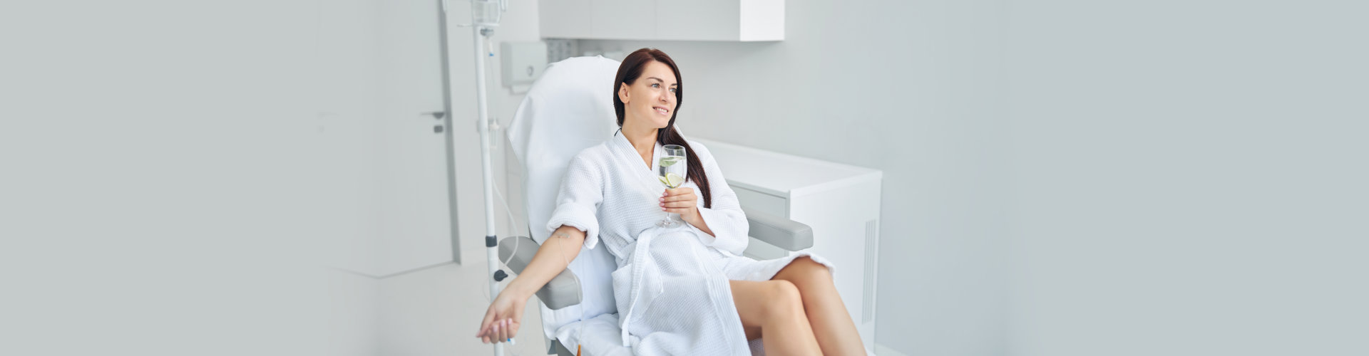 a woman holding a glass of water while doing therapy