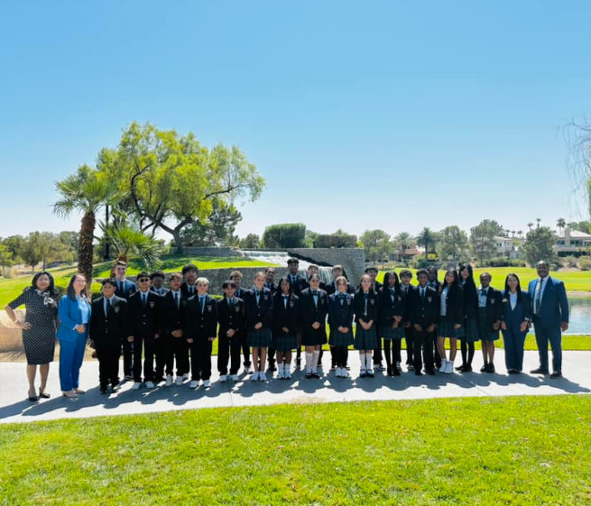 students and school staff taking a class photo