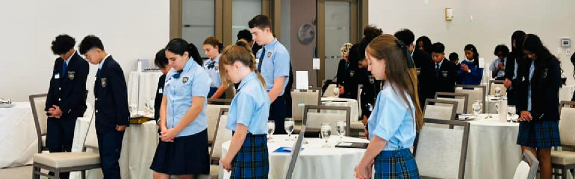 students bowing their heads