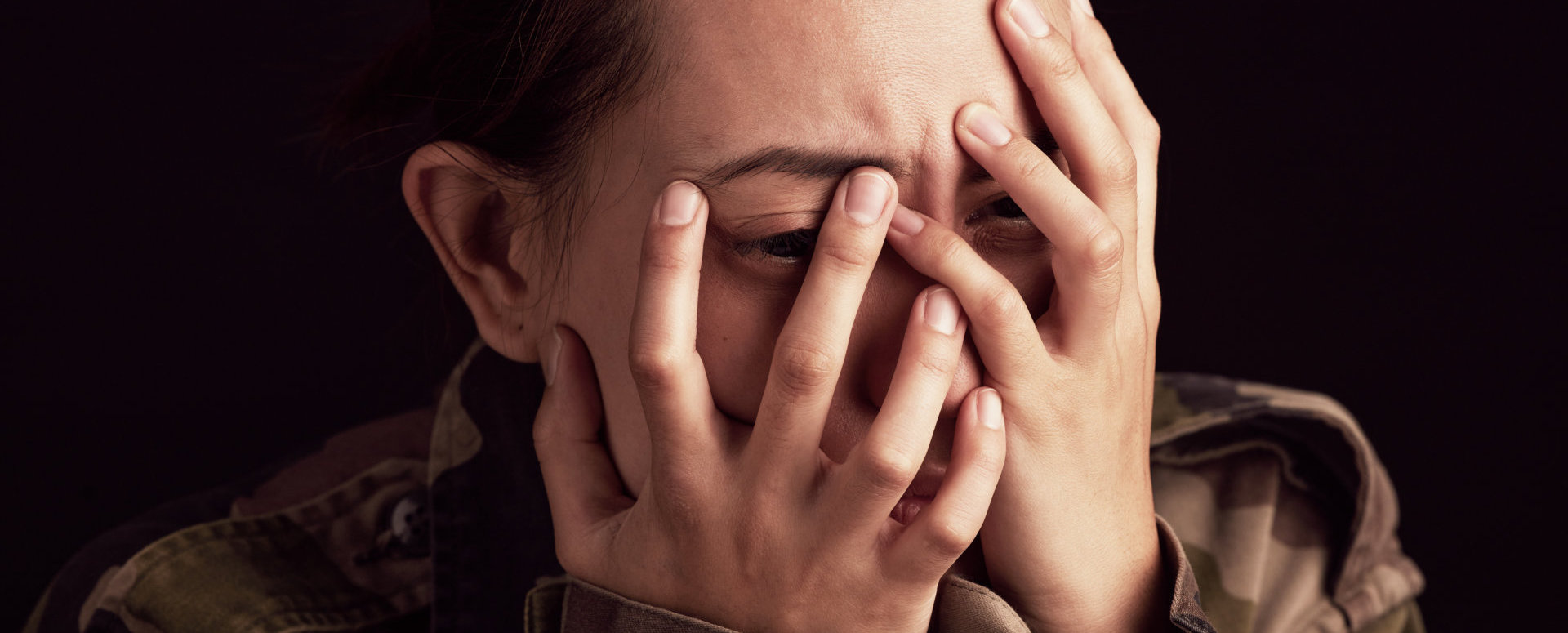 woman covering her face