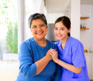 elderly and caregiver smiling