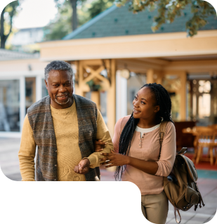 woman helping senior to walk
