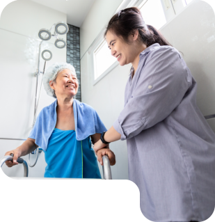 woman taking care of grandma taking bath