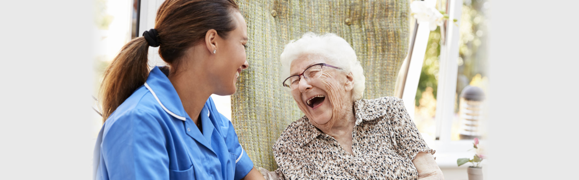 caregiver and woman laughing