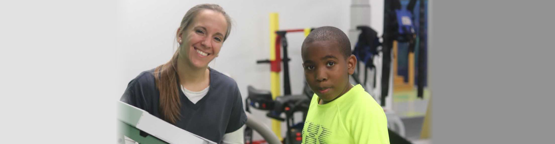 African-American boy wearing yellow shirt and a woman