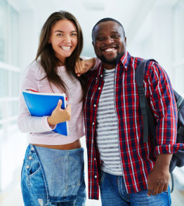 Happy teenage guy and a girl looking at camera