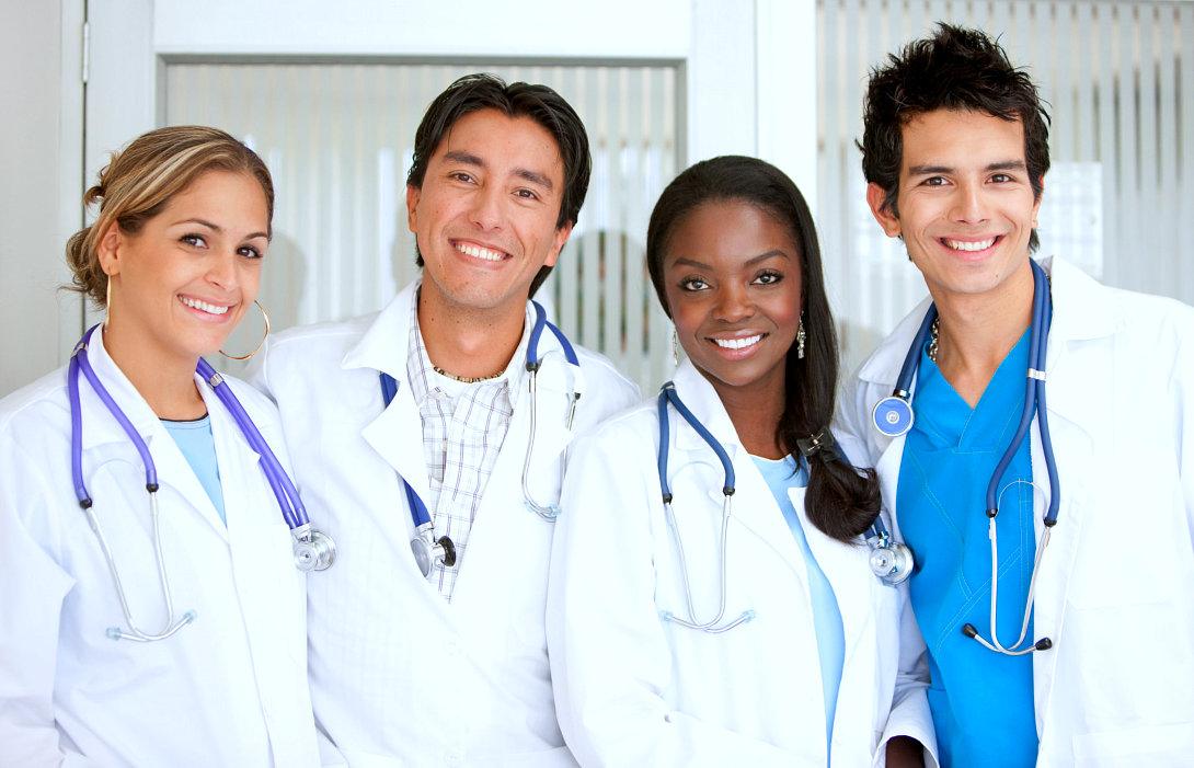 A group of doctors standing at the hospital smiling