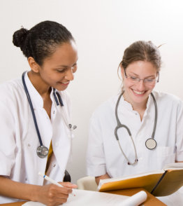 Two young medical students laughing together