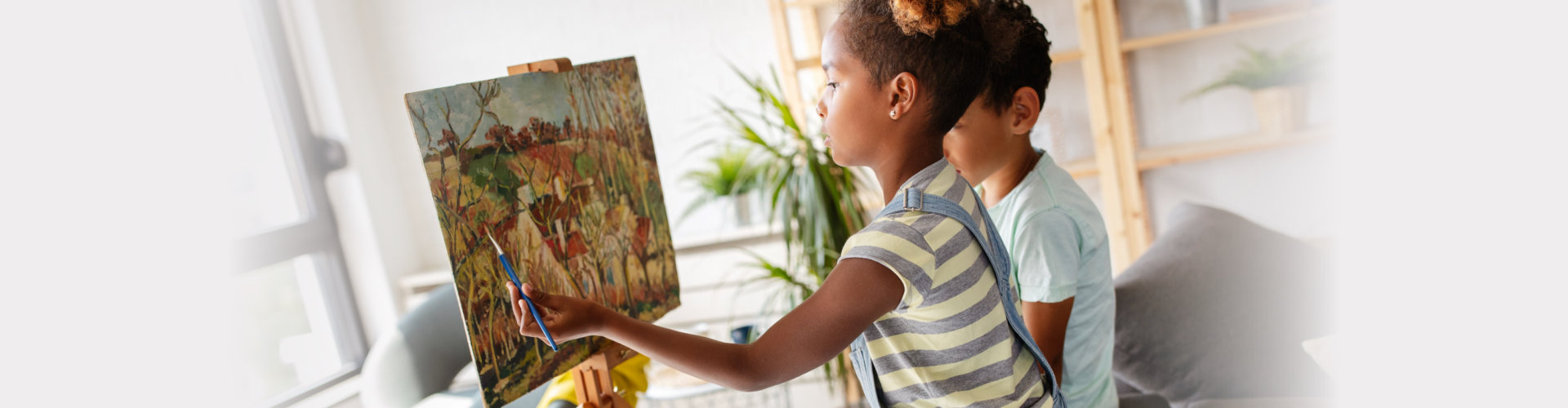 Cute children girl and boy painting together