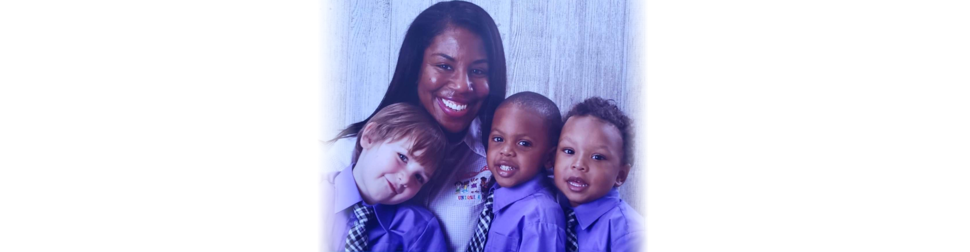 woman with three kids smiling