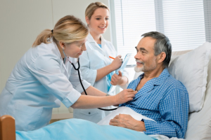 doctor examining a senior patient in hospital